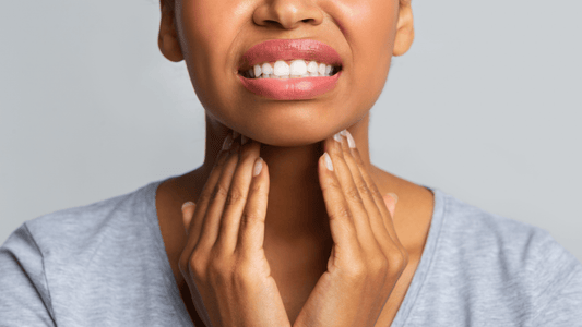 Woman holding her sore throat