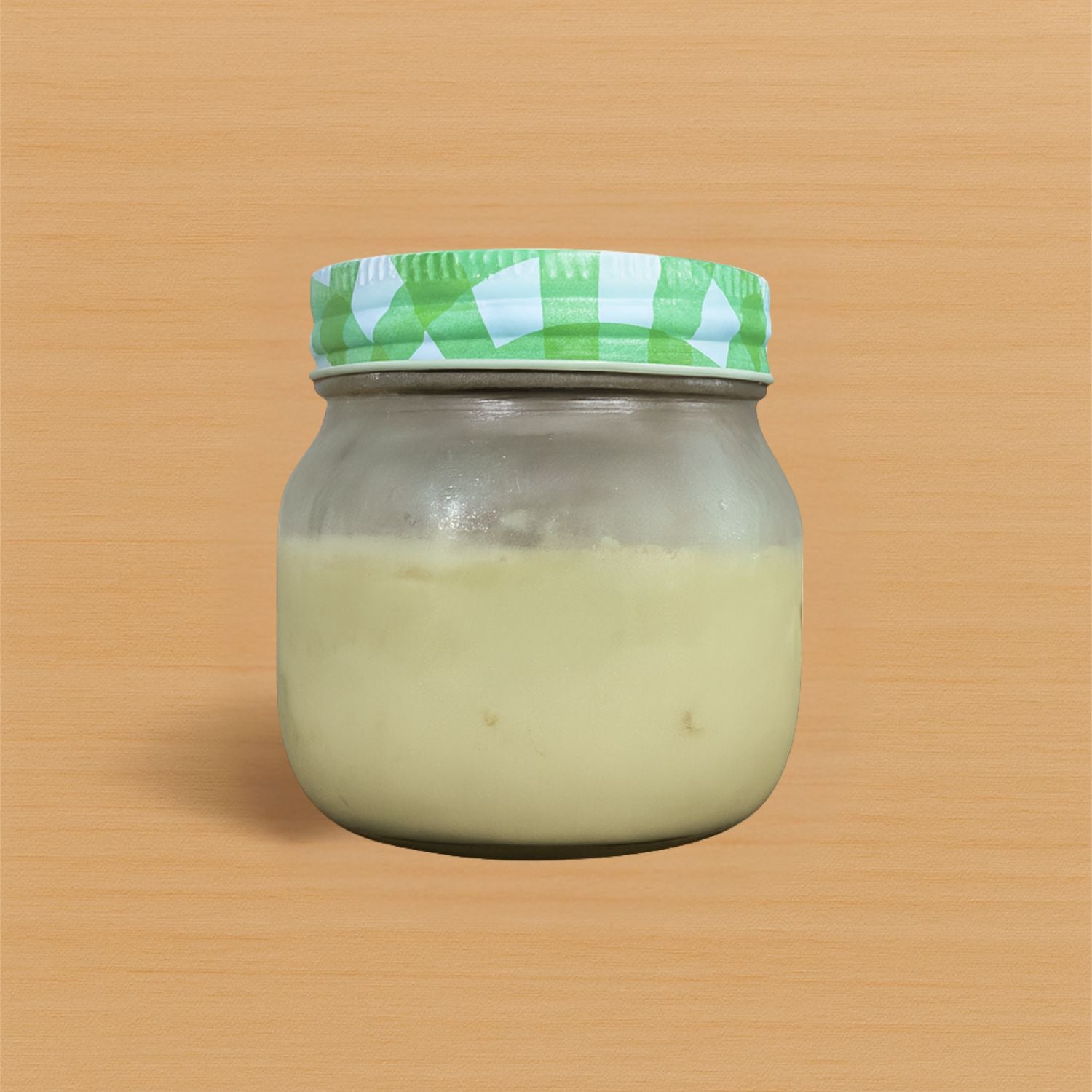 Glass jar with a green and white checkered lid on a wooden surface