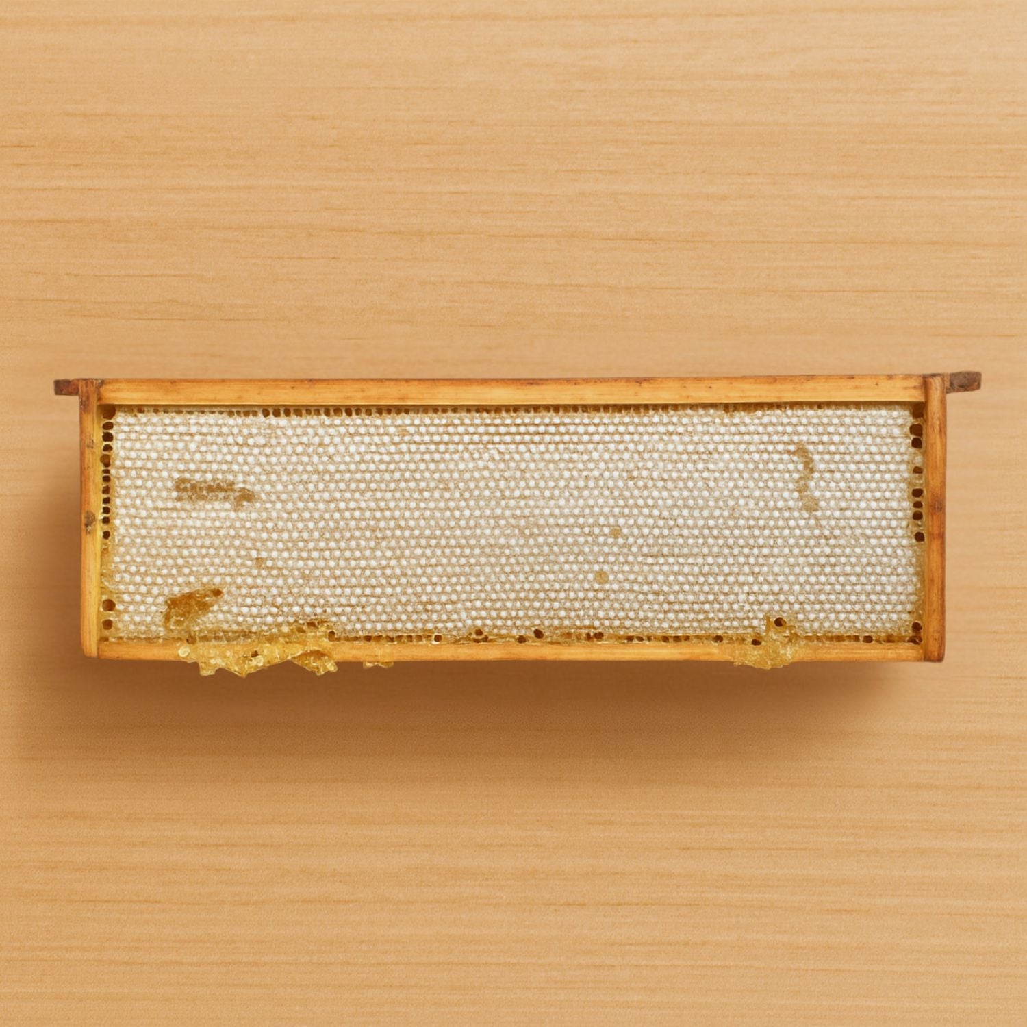 Honeycomb frame on a wooden background